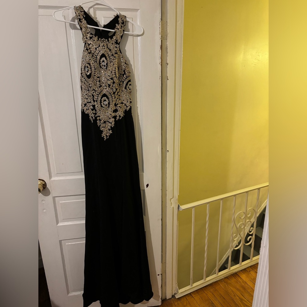 Black and gold rhinestone prom dress from brand called let’s.